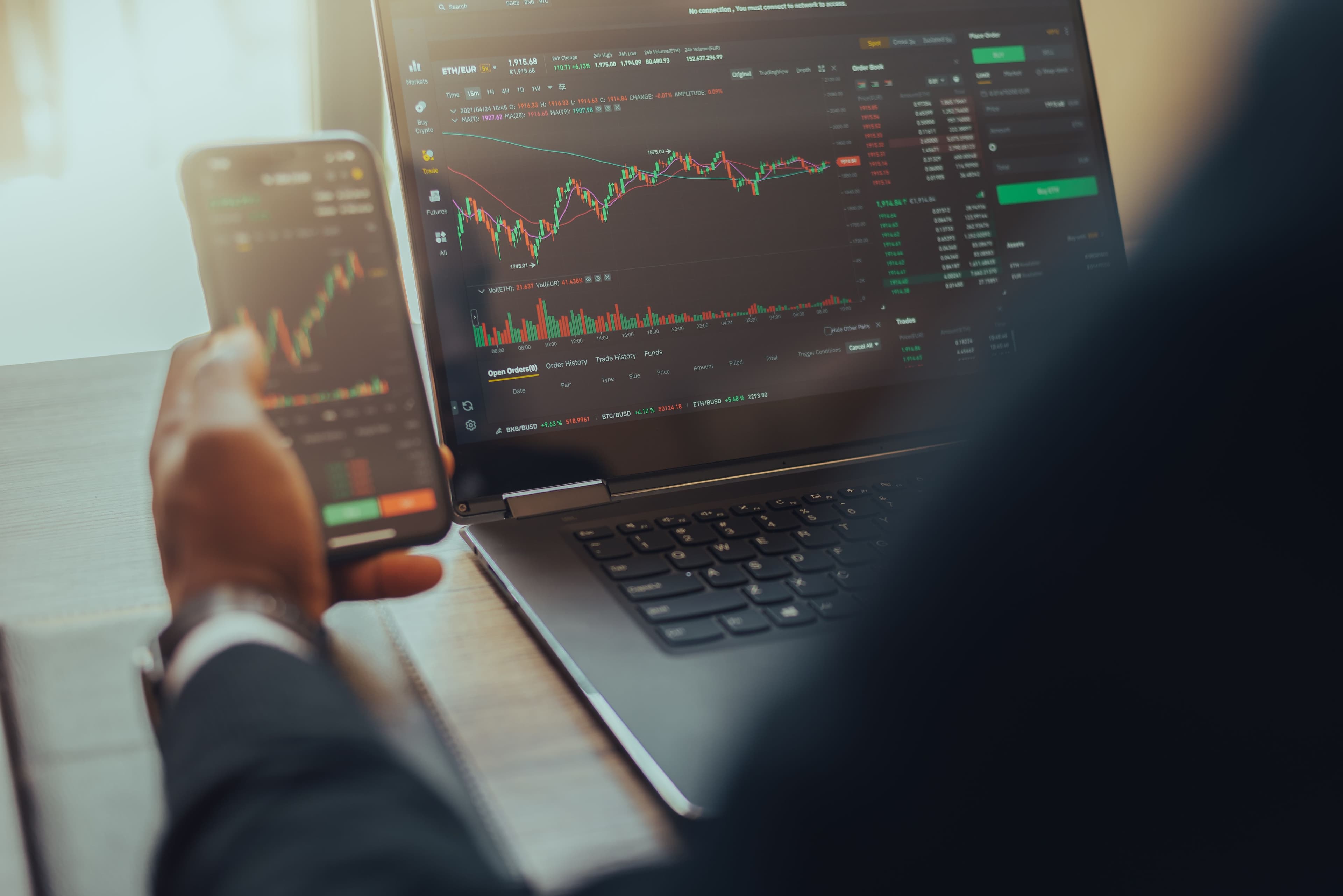 Trader on laptop and mobile comparing trading journal platforms for prop firm evaluation